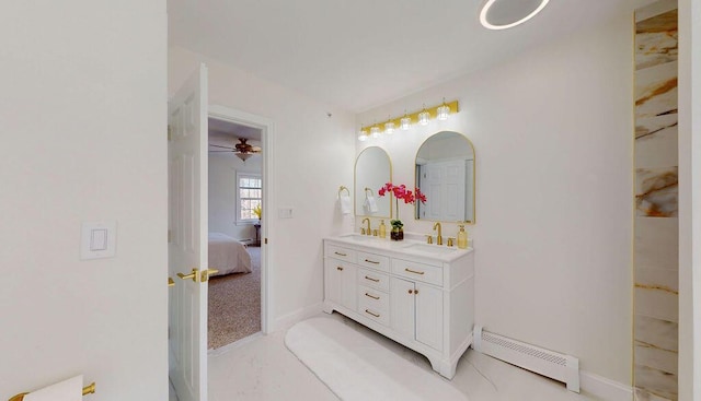 12 Summit Ter, Falmouth, ME 04105 - ensuite bathroom featuring double vanity, a baseboard radiator, a sink, and connected bathroom