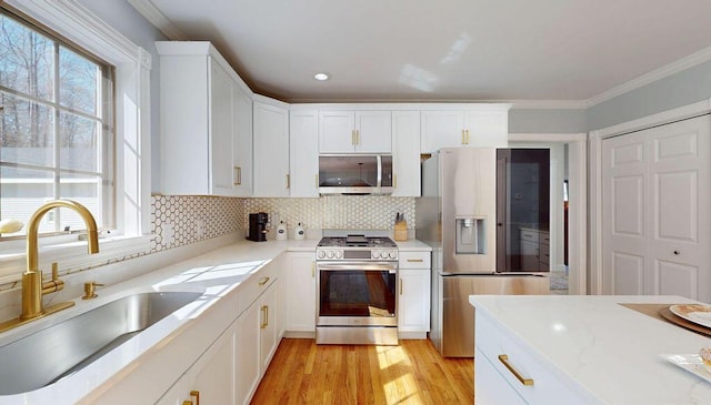 12 Summit Ter, Falmouth, ME 04105 - kitchen featuring a sink, appliances with stainless steel finishes, white cabinetry, and a wealth of natural light