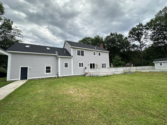 12 Summit Ter, Falmouth, ME 04105 - back of house with a lawn, a deck, fence, and a chimney