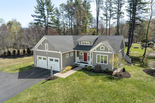 3 Flagship Cir, Kennebunk, ME 04043 - craftsman-style house with driveway, a garage, a front yard, a shingled roof, and view of scattered trees