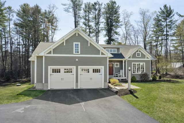3 Flagship Cir, Kennebunk, ME 04043 - craftsman house featuring asphalt driveway, a garage, a front yard, a porch, and roof with shingles