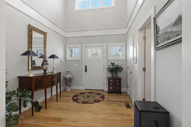 3 Flagship Cir, Kennebunk, ME 04043 - foyer with healthy amount of natural light, light wood-type flooring, a high ceiling, and baseboards