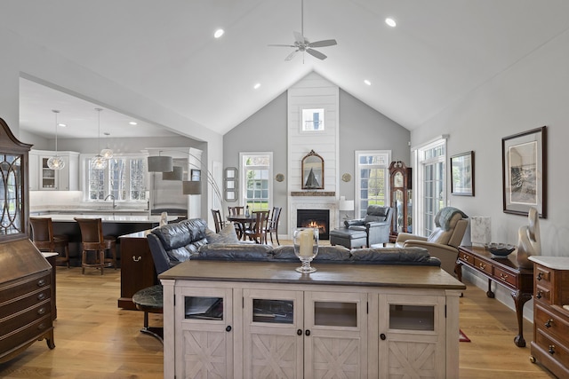 3 Flagship Cir, Kennebunk, ME 04043 - living area with a ceiling fan, light wood finished floors, high vaulted ceiling, a fireplace, and recessed lighting