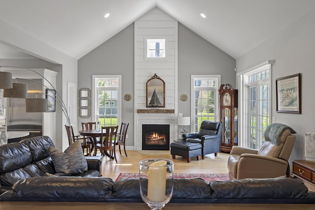 3 Flagship Cir, Kennebunk, ME 04043 - living area featuring high vaulted ceiling, healthy amount of natural light, wood finished floors, a large fireplace, and recessed lighting