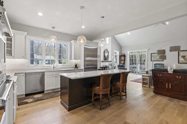 3 Flagship Cir, Kennebunk, ME 04043 - kitchen with appliances with stainless steel finishes, open floor plan, a sink, white cabinets, and light wood-style floors