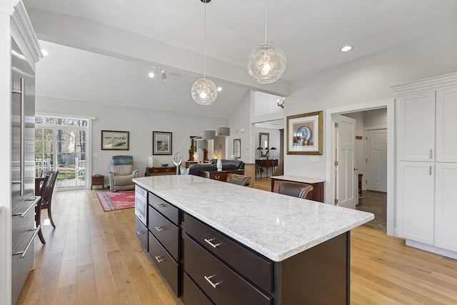 3 Flagship Cir, Kennebunk, ME 04043 - kitchen with lofted ceiling, light countertops, white cabinets, light wood-style flooring, and a center island