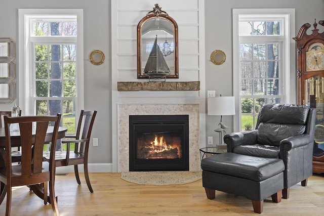 3 Flagship Cir, Kennebunk, ME 04043 - living area with wood finished floors, healthy amount of natural light, and a fireplace