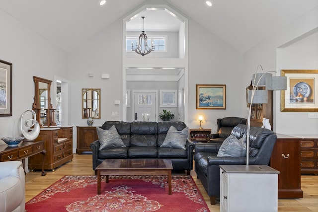 3 Flagship Cir, Kennebunk, ME 04043 - living room featuring high vaulted ceiling, a chandelier, and light wood-style floors