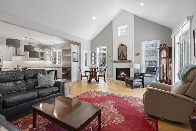 3 Flagship Cir, Kennebunk, ME 04043 - living area with light wood-style flooring, high vaulted ceiling, a large fireplace, and recessed lighting