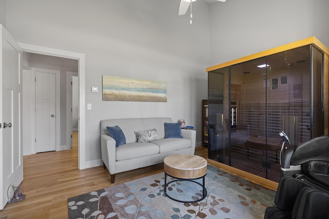 3 Flagship Cir, Kennebunk, ME 04043 - living area featuring wood finished floors, baseboards, a ceiling fan, and a towering ceiling