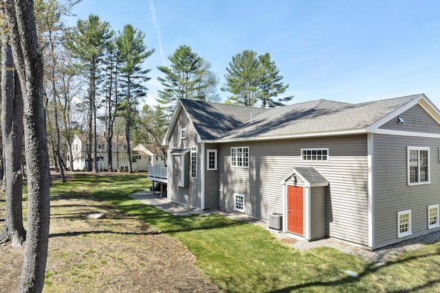 3 Flagship Cir, Kennebunk, ME 04043 - view of side of property with central AC unit, a lawn, and roof with shingles