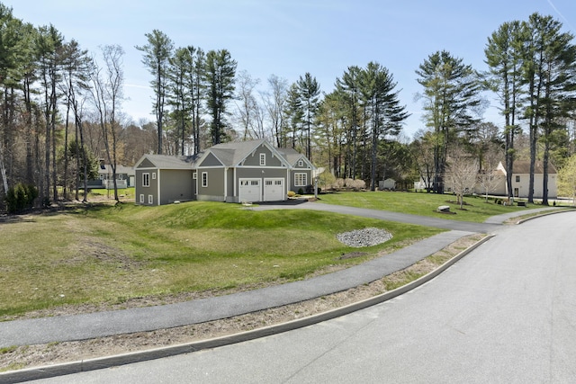 3 Flagship Cir, Kennebunk, ME 04043 - traditional-style home with asphalt driveway, a garage, a front lawn, and view of wooded area