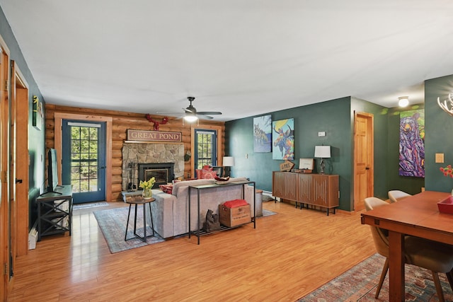 370 Point Rd, Belgrade, ME 04917 - living area featuring a ceiling fan, a stone fireplace, and light wood-style floors