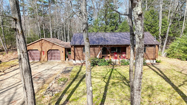 370 Point Rd, Belgrade, ME 04917 - cabin featuring log siding, an attached garage, driveway, and a front lawn