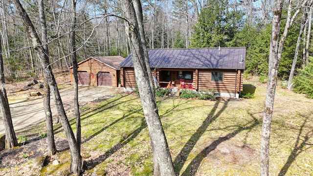 370 Point Rd, Belgrade, ME 04917 - view of front of property with a front yard, log siding, metal roof, concrete driveway, and an attached garage