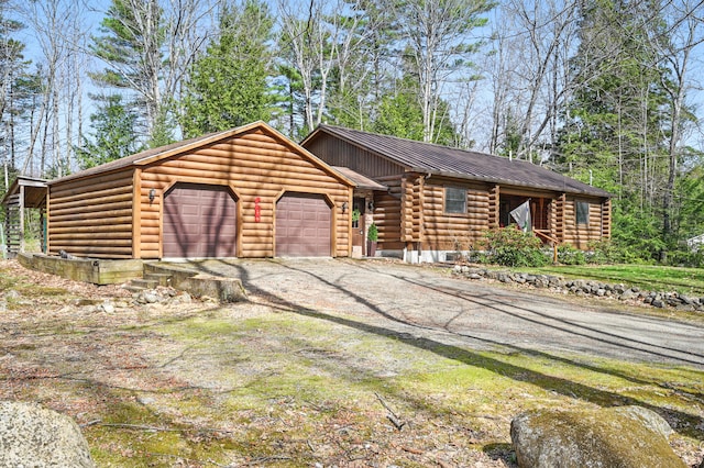 370 Point Rd, Belgrade, ME 04917 - cabin with a standing seam roof, dirt driveway, log exterior, metal roof, and an attached garage