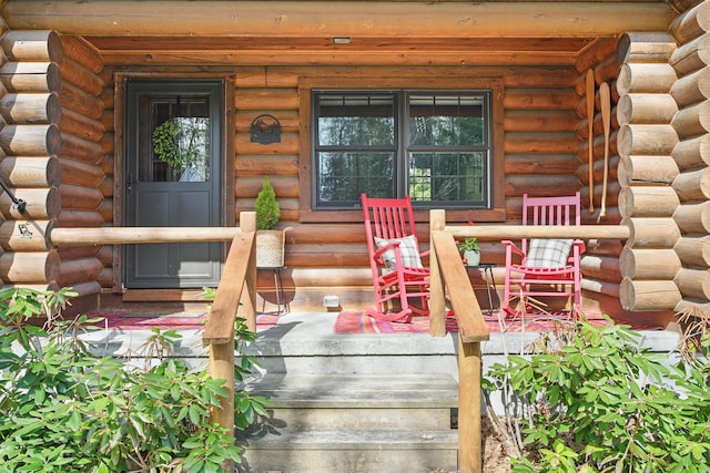 370 Point Rd, Belgrade, ME 04917 - doorway to property featuring log siding and covered porch