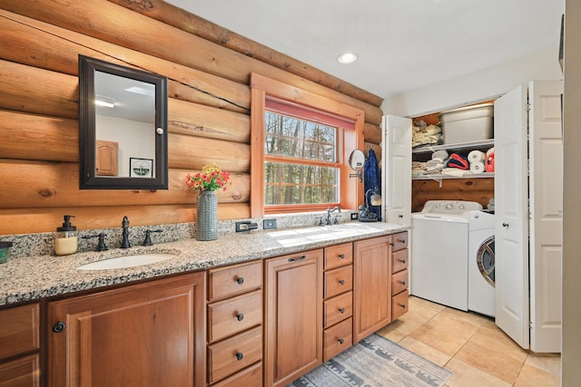 370 Point Rd, Belgrade, ME 04917 - laundry room with a sink, log walls, light tile patterned floors, and washing machine and dryer