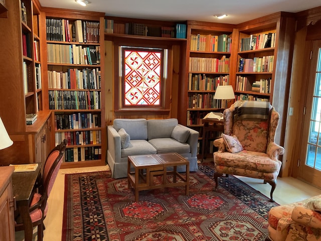 living area featuring wall of books