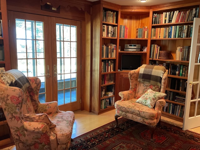 sitting room with french doors, wood finished floors, and a wealth of natural light