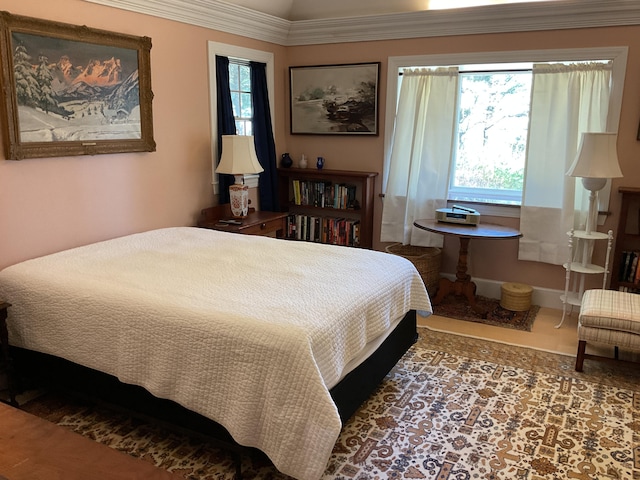 bedroom with baseboards and multiple windows