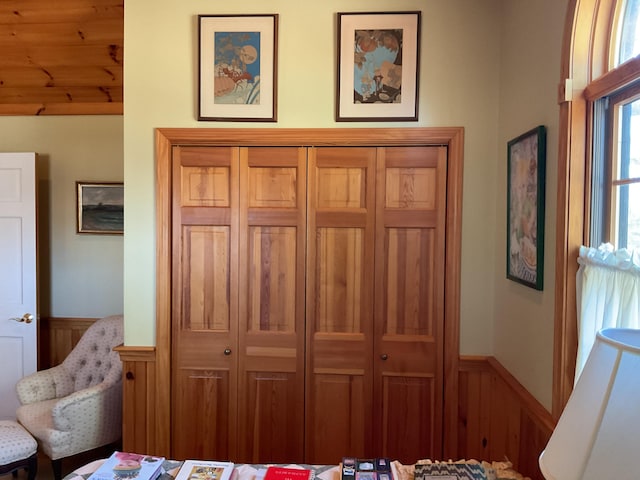 bedroom with a closet and wainscoting