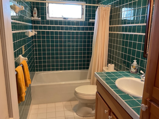full bath with tile patterned flooring, shower / tub combo, toilet, and vanity