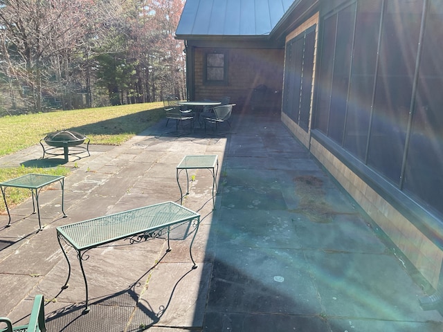 view of patio featuring outdoor dining area and a fire pit