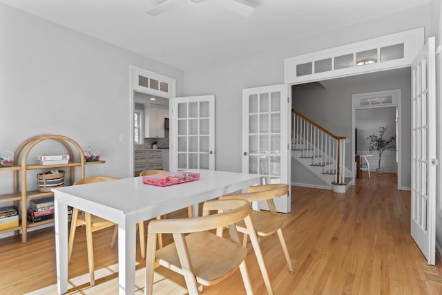36 Fort Hill Ave, York, ME 03909 - dining area featuring a ceiling fan, french doors, stairway, baseboards, and light wood-style flooring
