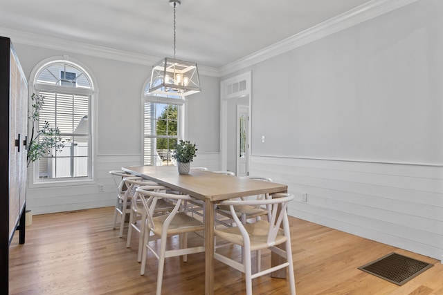 36 Fort Hill Ave, York, ME 03909 - dining room with visible vents, light wood finished floors, wainscoting, and a wealth of natural light