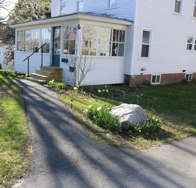 view of side of property featuring a sunroom