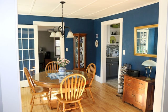 dining area featuring an inviting chandelier and light wood-type flooring