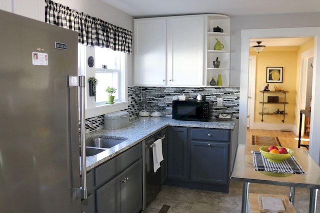 kitchen with freestanding refrigerator, open shelves, black microwave, tasteful backsplash, and dishwasher
