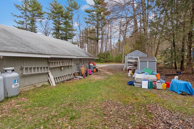 224 Branch Rd, Wells, ME 04090 - view of green lawn with a storage unit and an outbuilding
