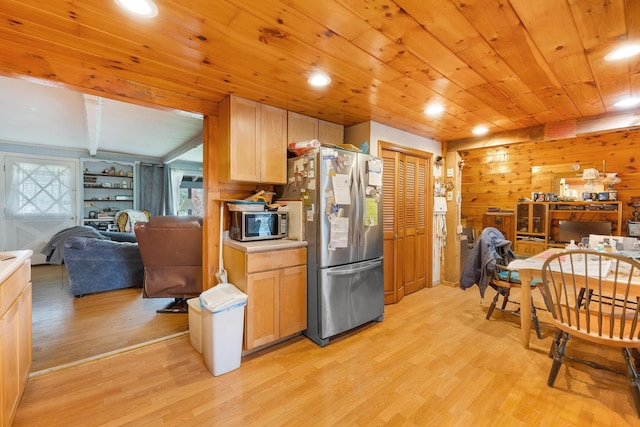 224 Branch Rd, Wells, ME 04090 - kitchen featuring open floor plan, stainless steel appliances, light wood finished floors, wood walls, and wooden ceiling