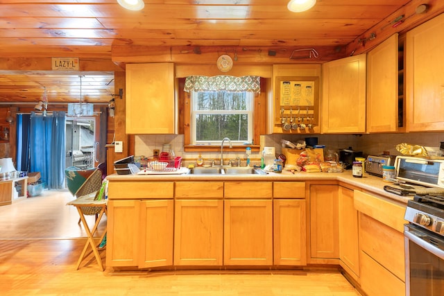 224 Branch Rd, Wells, ME 04090 - kitchen featuring wood ceiling, a sink, light countertops, gas stove, and tasteful backsplash