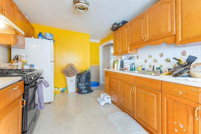 224 Branch Rd, Wells, ME 04090 - kitchen with black gas range oven, light countertops, under cabinet range hood, and decorative backsplash