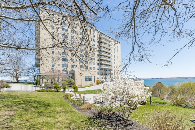 45 Eastern Promenade Unit 1E, Portland, ME 04101 - surrounding community with fence, a water view, and a lawn