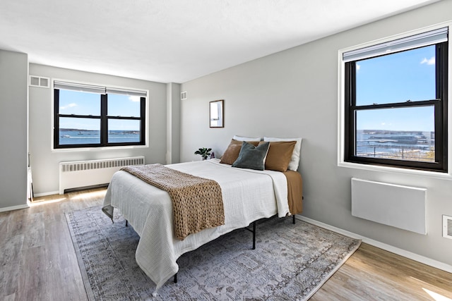 45 Eastern Promenade Unit 1E, Portland, ME 04101 - bedroom with radiator, baseboards, wood finished floors, and visible vents