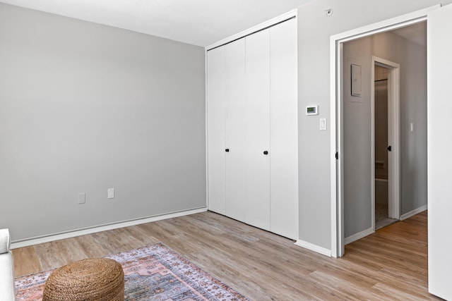 45 Eastern Promenade Unit 1E, Portland, ME 04101 - unfurnished bedroom with baseboards, light wood finished floors, and a closet