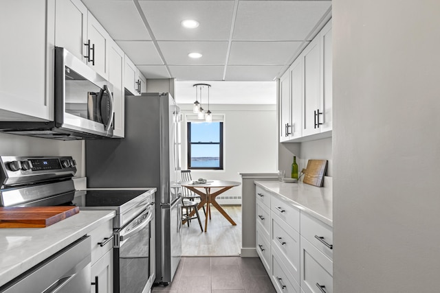 45 Eastern Promenade Unit 1E, Portland, ME 04101 - kitchen featuring a drop ceiling, recessed lighting, white cabinetry, tile patterned floors, and stainless steel appliances