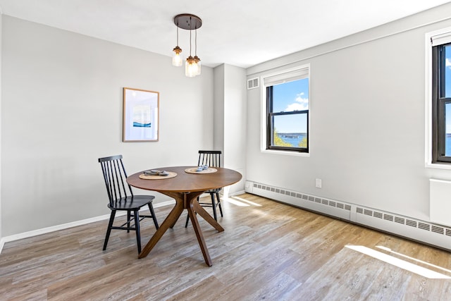 45 Eastern Promenade Unit 1E, Portland, ME 04101 - dining space with visible vents, a baseboard radiator, baseboards, and wood finished floors
