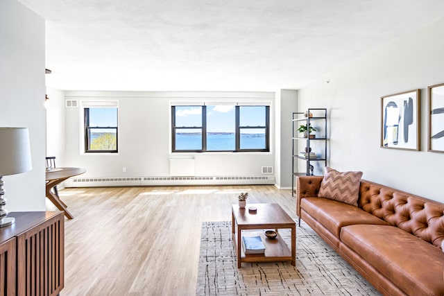 45 Eastern Promenade Unit 1E, Portland, ME 04101 - living room with baseboards, a baseboard heating unit, and wood finished floors
