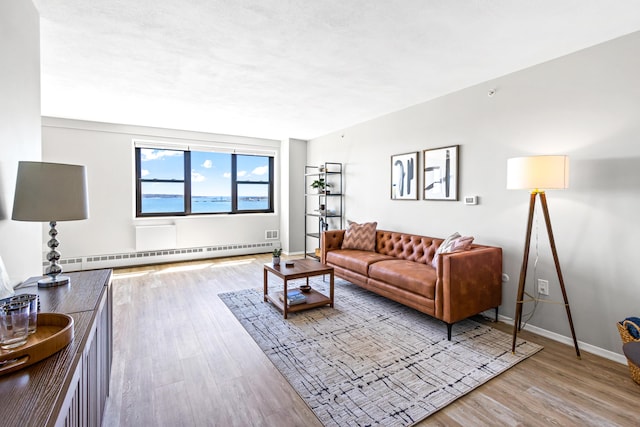 45 Eastern Promenade Unit 1E, Portland, ME 04101 - living area featuring baseboards, wood finished floors, and baseboard heating