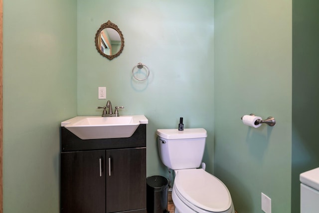 bathroom with toilet and vanity