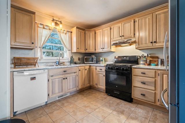 kitchen featuring black gas stove, dishwasher, a sink, freestanding refrigerator, and under cabinet range hood