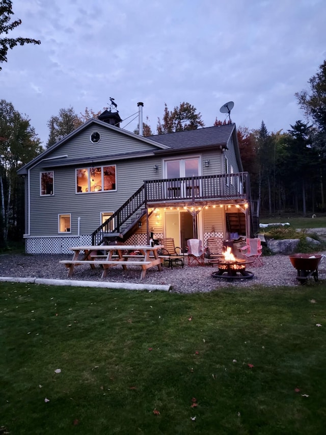 17 Kokadjo N Rd, Frenchtown Twp, ME 04441 - rear view of property with a fire pit, a wooden deck, stairs, a yard, and a patio