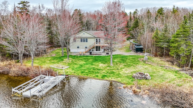 17 Kokadjo N Rd, Frenchtown Twp, ME 04441 - dock area featuring a water view, a fire pit, a yard, stairway, and boat lift