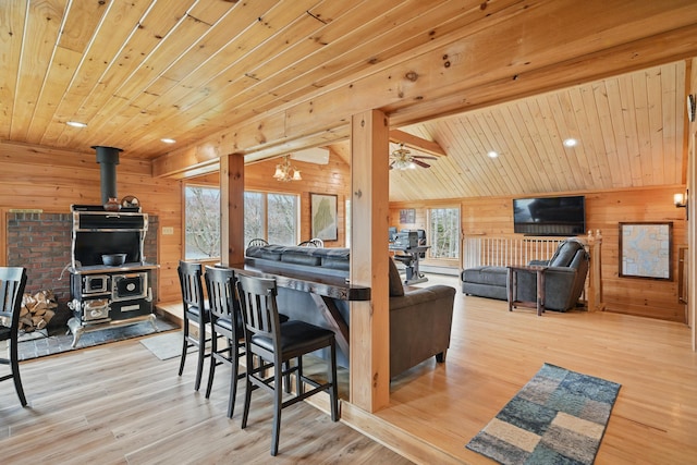 17 Kokadjo N Rd, Frenchtown Twp, ME 04441 - living area with a wood stove, wood walls, wood ceiling, wood finished floors, and recessed lighting