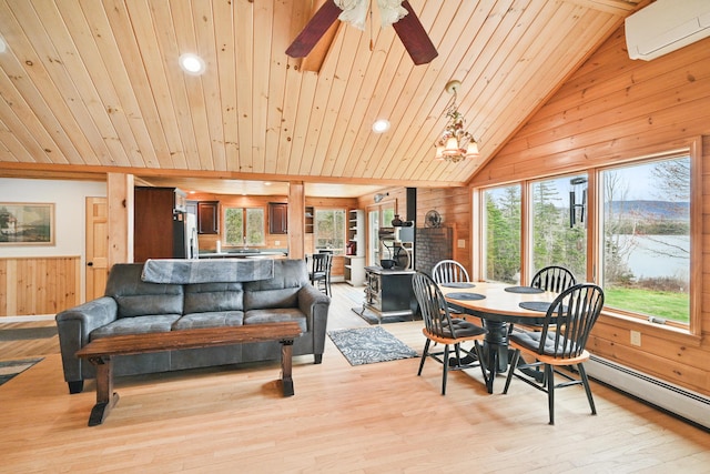 17 Kokadjo N Rd, Frenchtown Twp, ME 04441 - dining area with wooden walls, wooden ceiling, vaulted ceiling, a wall unit AC, and light wood-style flooring